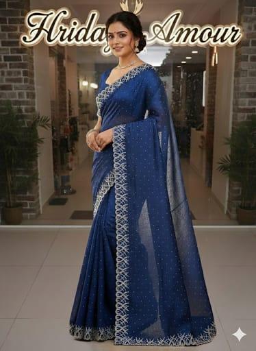 Model in a royal blue embellished saree with ornate silver border
