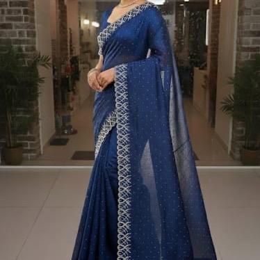 Model in a royal blue embellished saree with ornate silver border